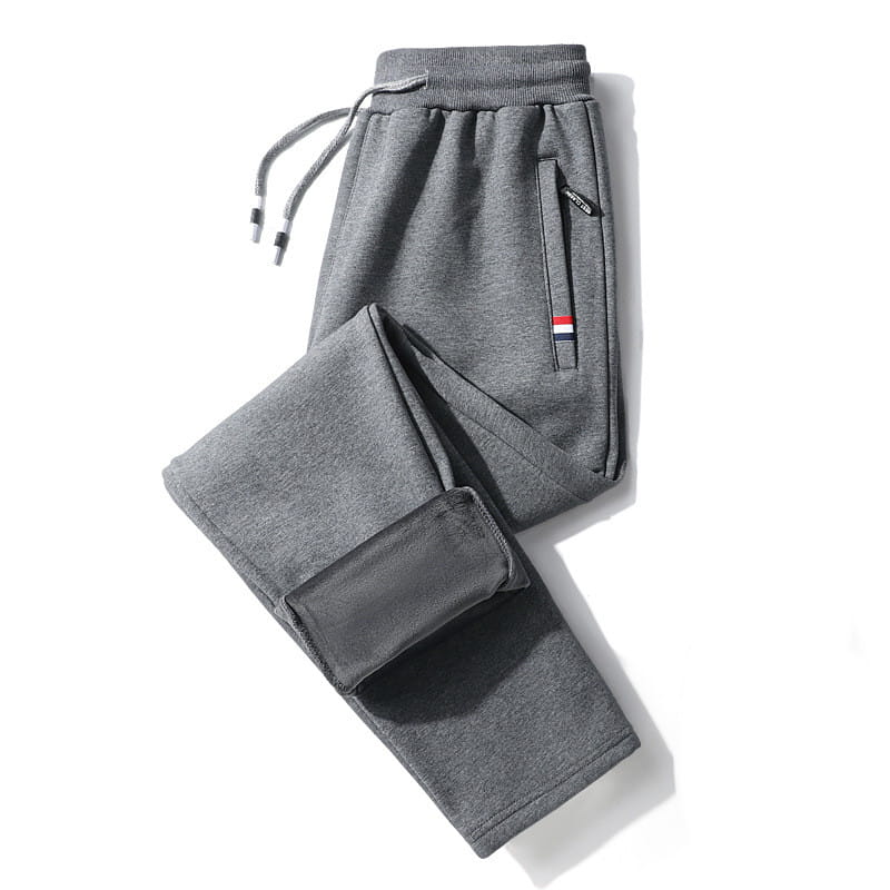 men fleece lined joggers in gray cotton with a drawstring waistband ribbed cuffs and a red white and blue stripe detail on the side pocket.