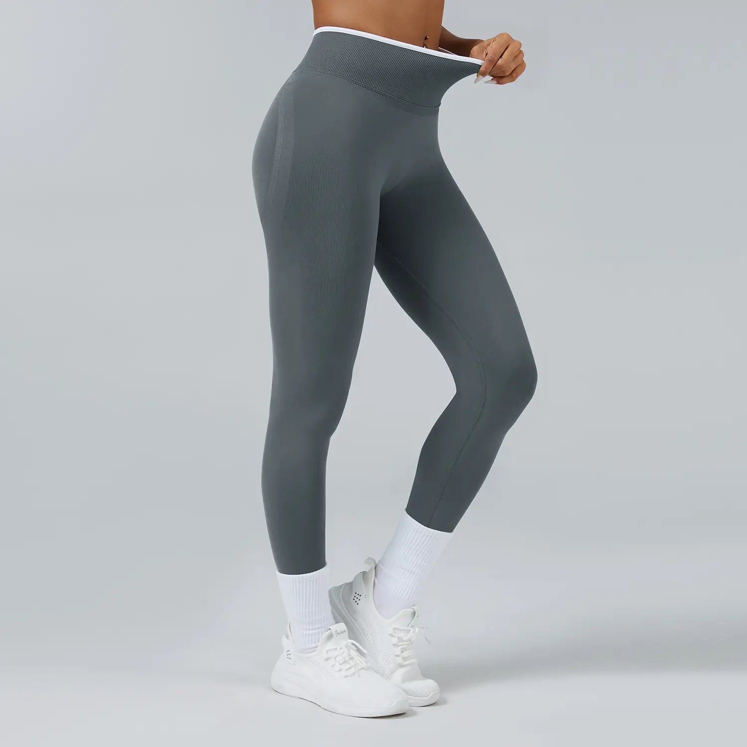 Graue nahtlose Sport-Yoga-Leggings mit hoher Taille mit strukturiertem Bund und figurbetontem Schnitt.