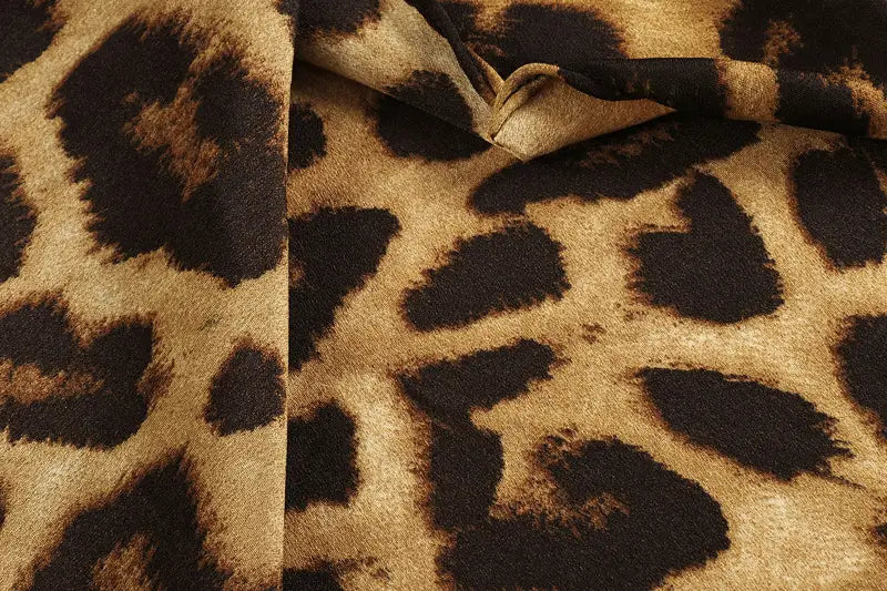 Leopard print v neck long sleeve chiffon wrap dress featuring faux fur fabric with a bold leopard print pattern in rich tan and deep black.