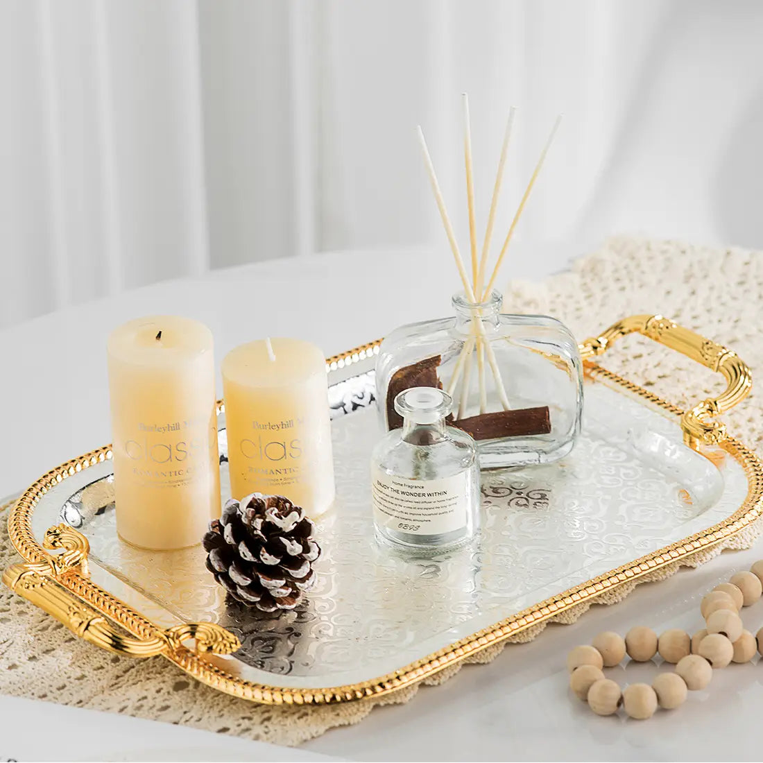Luxury rectangle serving tray with gold handles featuring an elegant gold-trimmed silver tray with ornate handles and embossed pattern.