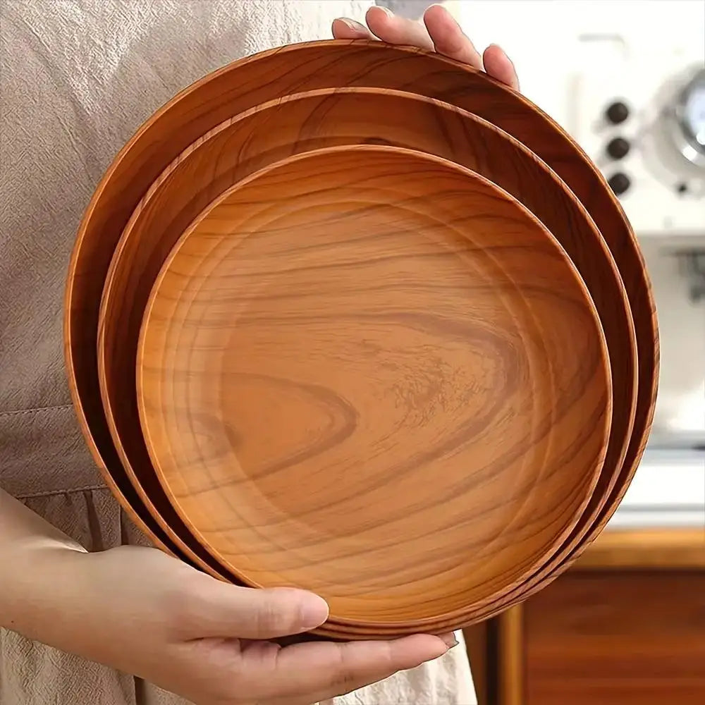 Set of three circular wooden plates with a warm natural brown finish and visible wood grain patterns from the wood grain plastic plates 10pc round striped design collection.