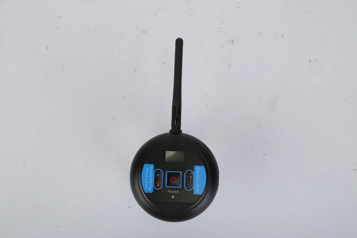 Black circular wireless dog fence system training collar with prominent antenna, blue-labeled buttons, and small digital display designed for waterproof use.