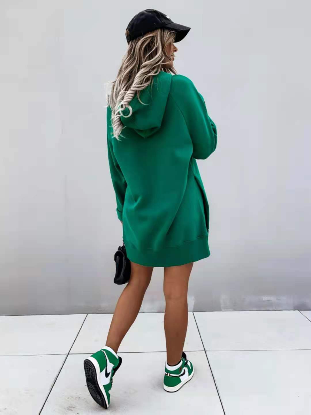 green oversized mid length hooded sweatshirt dress made of soft fabric with long sleeves and pockets
