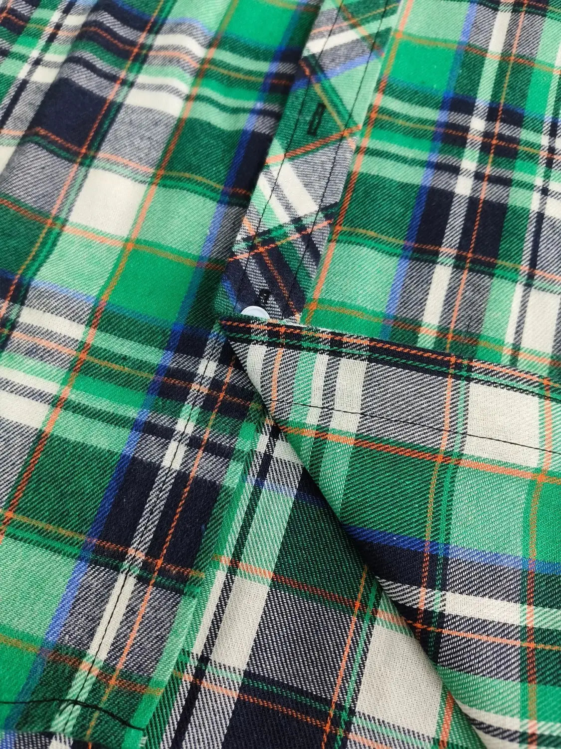 Men’s slim fit plaid flannel button up shirt fabric in green white navy blue and orange with a woven texture