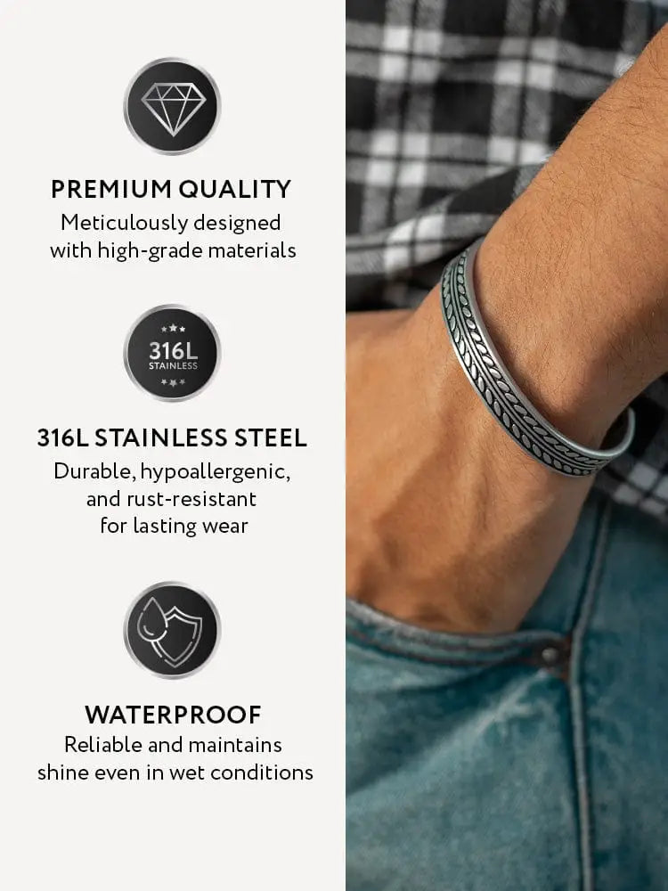 Silver 316l stainless steel cuff bangle featuring an intricate feather bone leaf pattern design