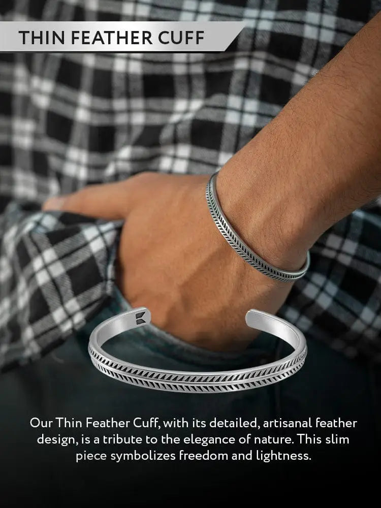 Silver stainless steel feather bone cuff bracelet with intricate parallel lines and small triangular inner edge motifs