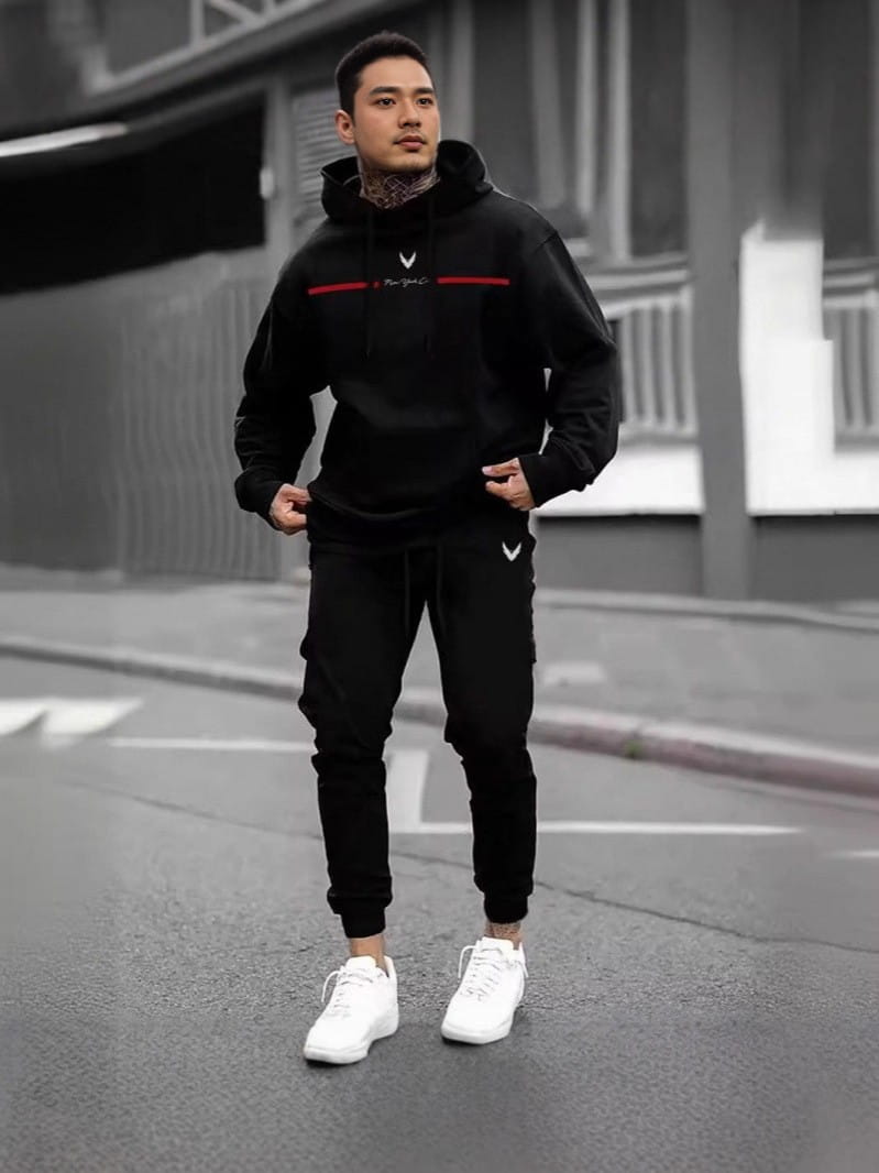 Men 3d digital print casual set featuring a black polyester hoodie with a red stripe across the chest and white logo on the left side paired with matching black joggers with a small white emblem on the lower leg.