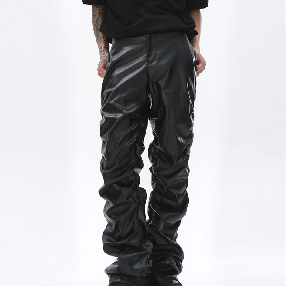Men’s black ruched glossy faux leather tapered pants with a slouchy and textured design.
