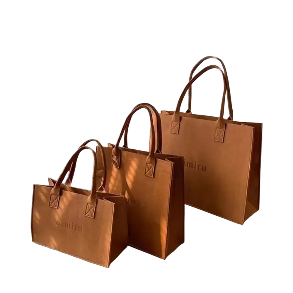 Brown leather tote bags with stitched handles and embossed branding designed for large capacity felt crossbody use