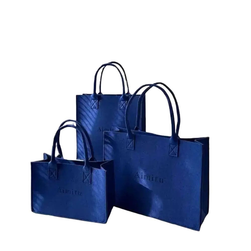 Set of three royal blue felt crossbody shoulder tote bags with structured design and embossed brand logo