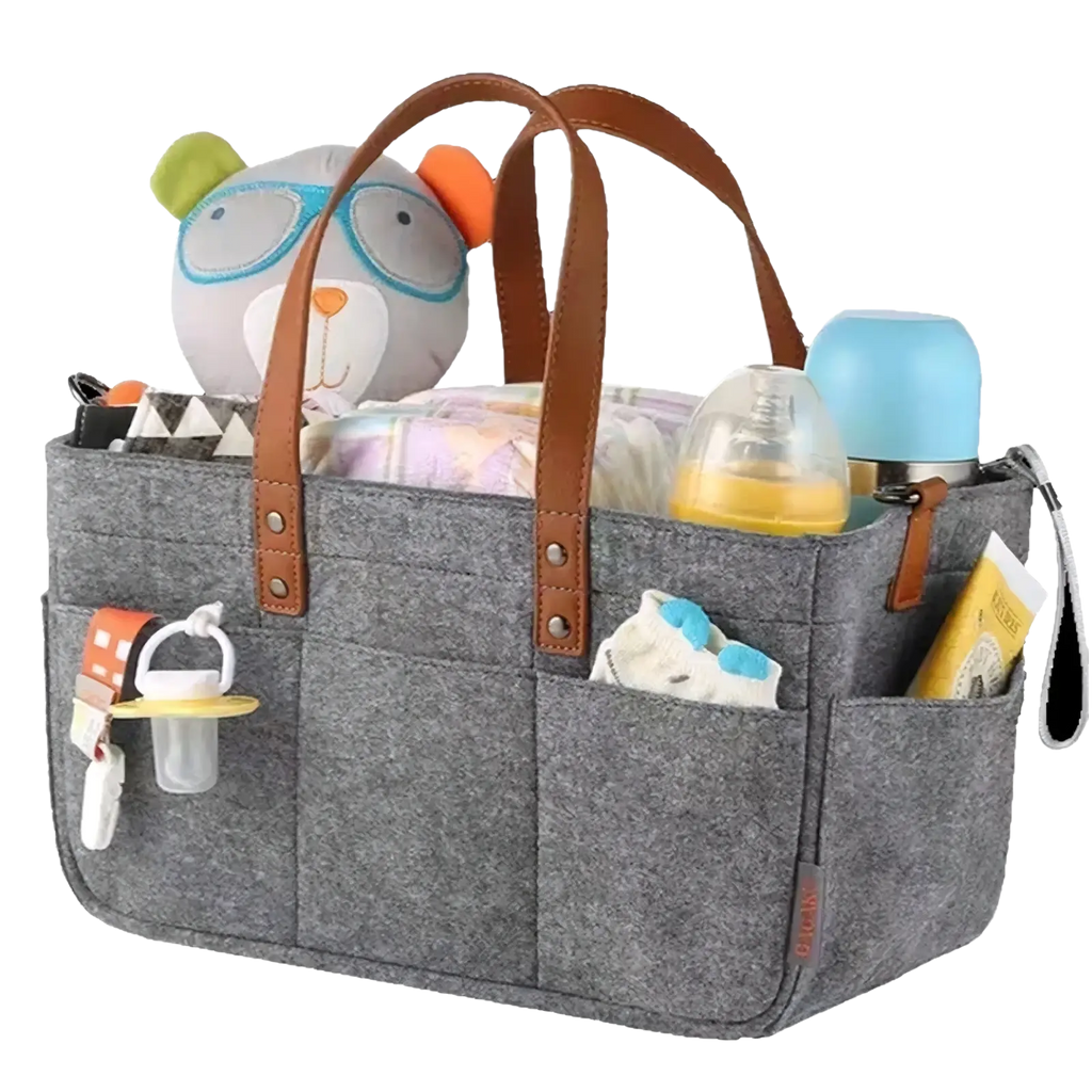 Gray felt diaper caddy nursery organizer basket with brown leather handles filled with diapers bottles and a plush toy