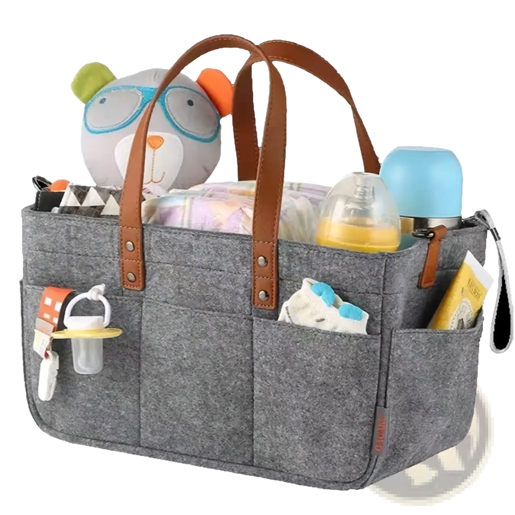 Gray felt diaper caddy nursery organizer basket with brown leather handles filled with diapers bottles and a plush toy