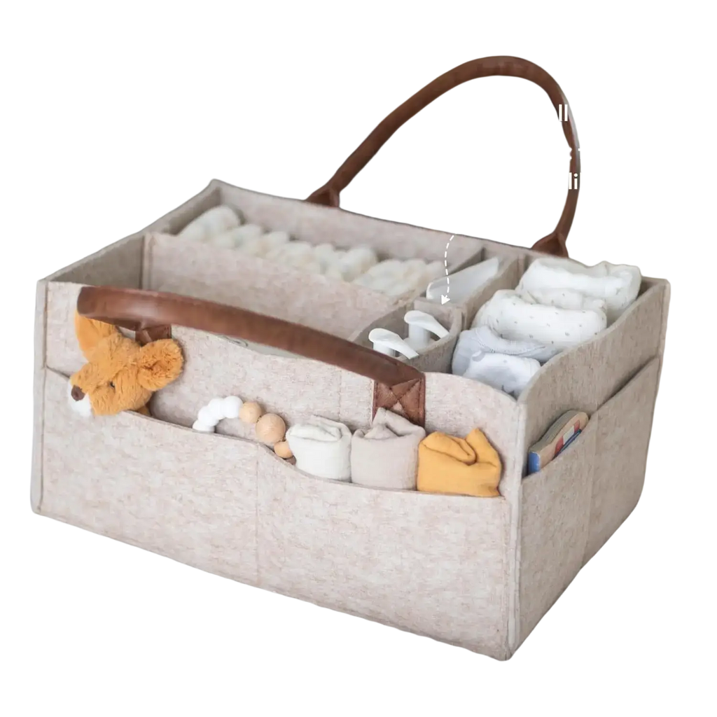 Beige felt diaper caddy nursery storage basket with brown leather handles and multiple compartments for baby essentials
