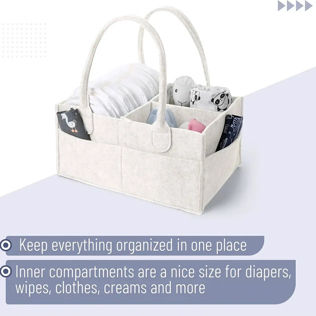 Beige felt diaper caddy nursery storage basket with two arched handles and multiple compartments for baby essentials