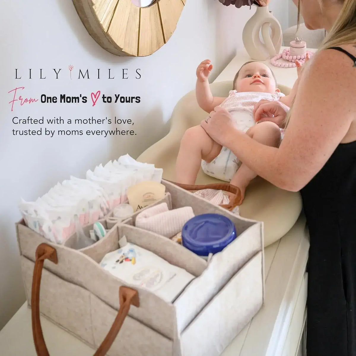 Beige felt diaper caddy nursery storage basket with brown leather handles and multiple compartments for organization
