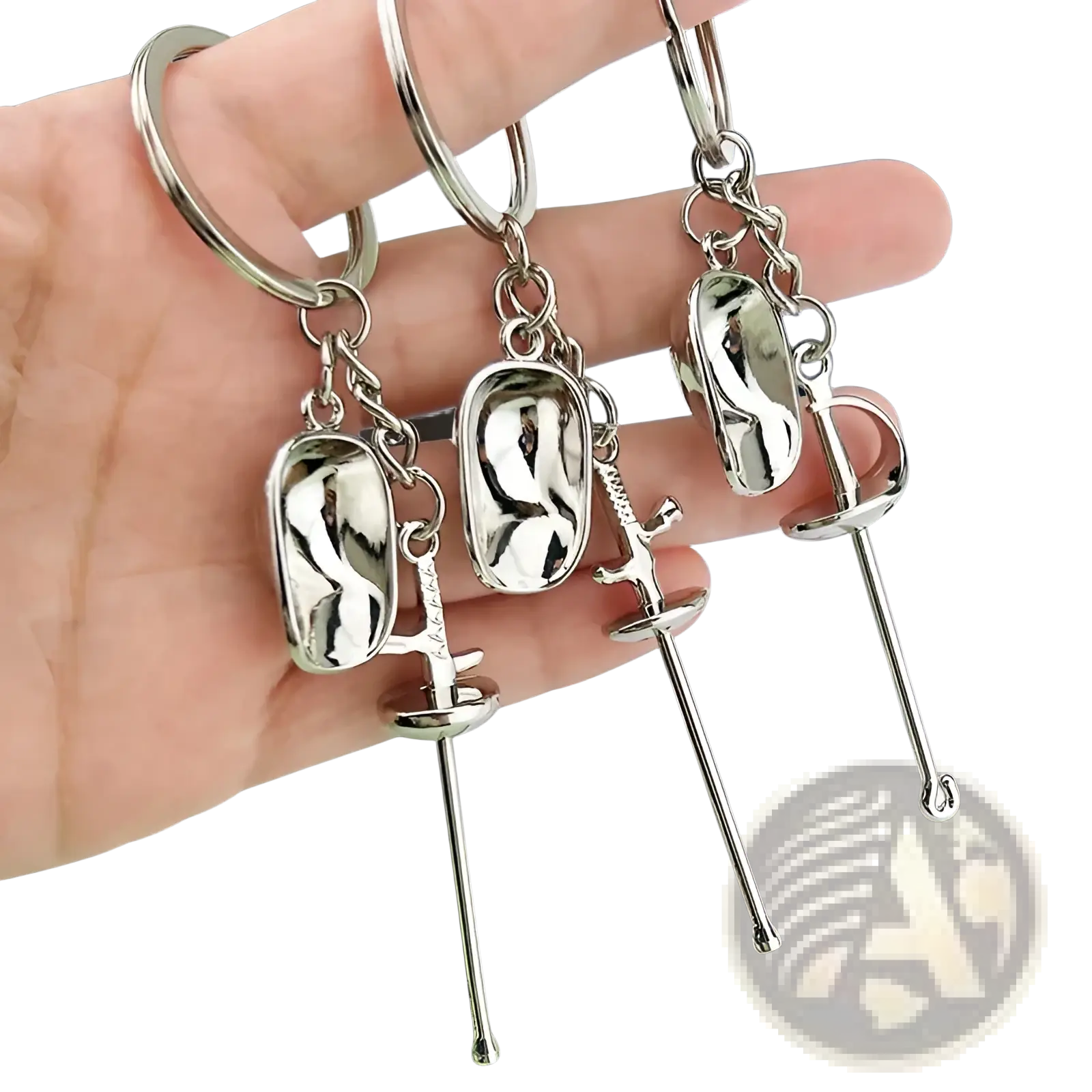 Silver metallic fencing keychains featuring miniature swords and oval protective gear charms made of metal sports jewelry