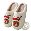 White plush winter slippers with festive embroidered reindeer faces wearing red hats and brown antlers