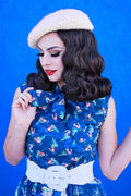 Cream-colored knitted beret displayed with festive fox print vintage bow blouse in blue size 1x