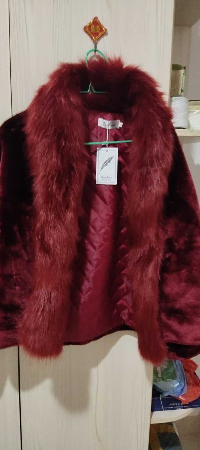A women padded coat with a plush deep red faux fur collar on a velvet jacket featuring a quilted lining for slim winter use.