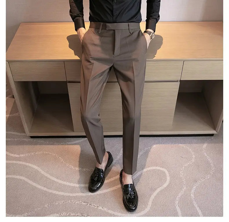 A pair of men’s slim fit British style tailored straight leg trousers in dark gray with belt loops.