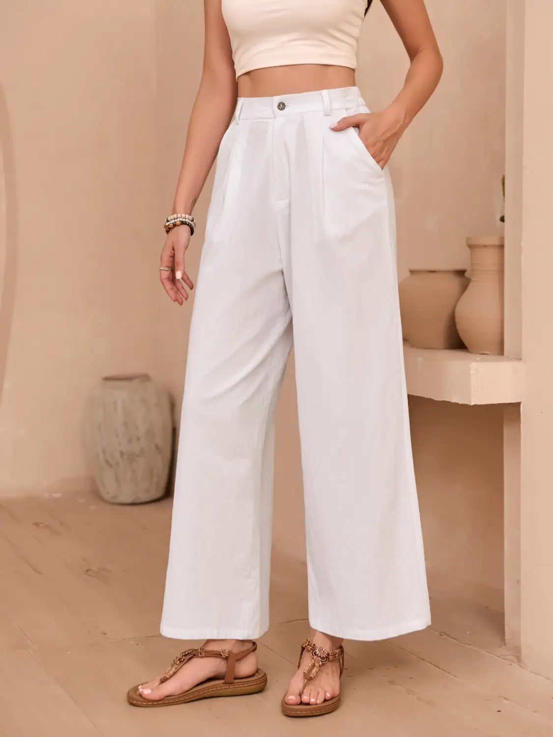Linen wide leg high waisted pants in white featuring a minimalist design and wide leg silhouette.
