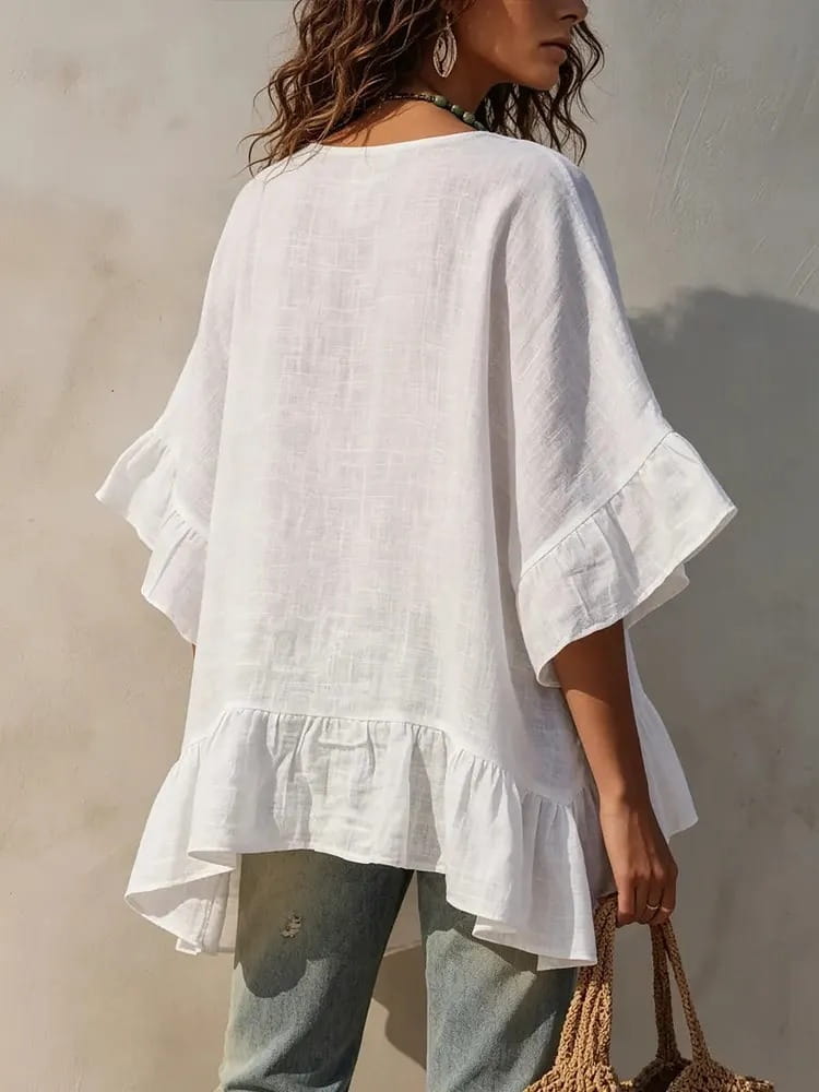 White linen cotton shirt with ruffled sleeves and ruffle hem detail.