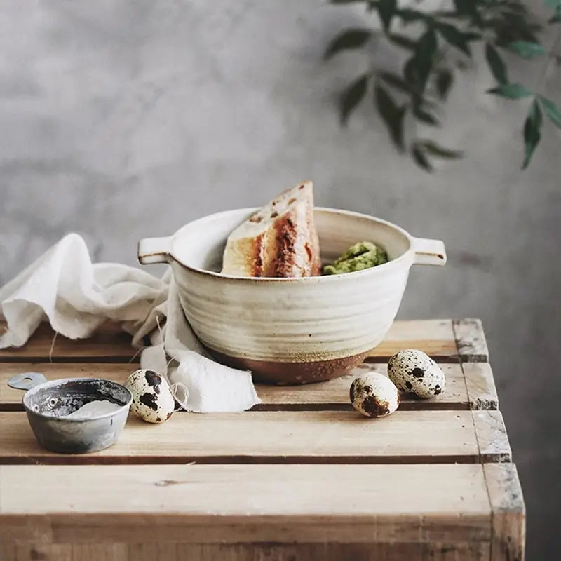 Cream-colored Japanese stoneware 6 inch binaural ceramic soup bowl with two handles and a rustic handcrafted finish.