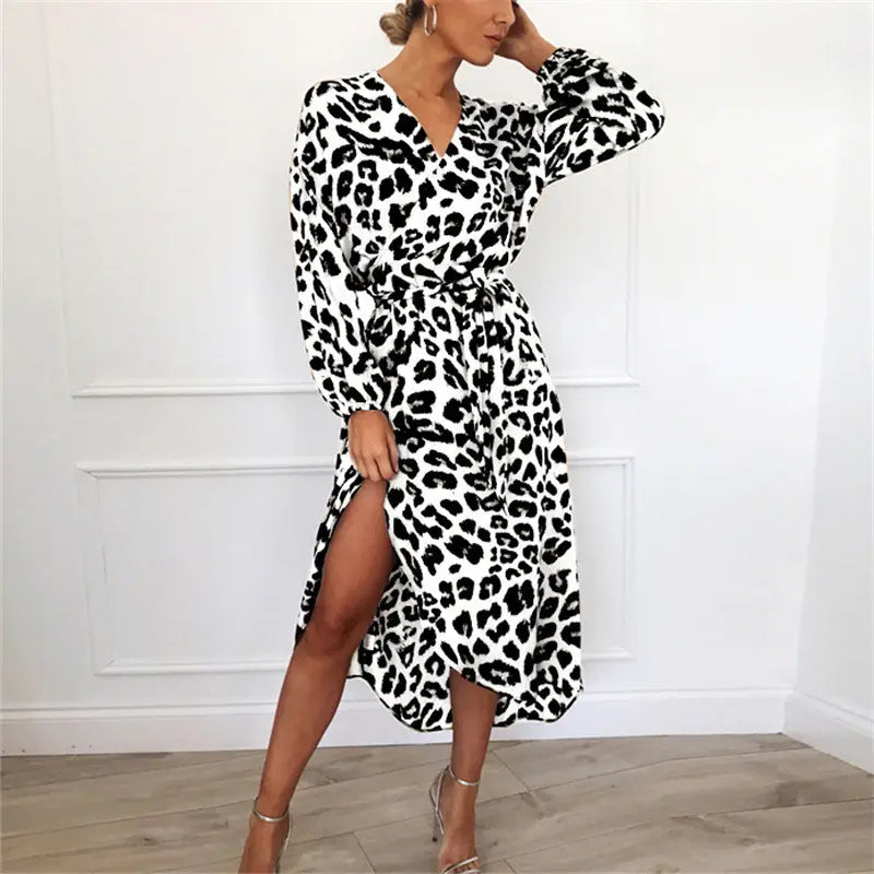 A black and white leopard print chiffon wrap dress with long sleeves a v-neckline and a side slit.