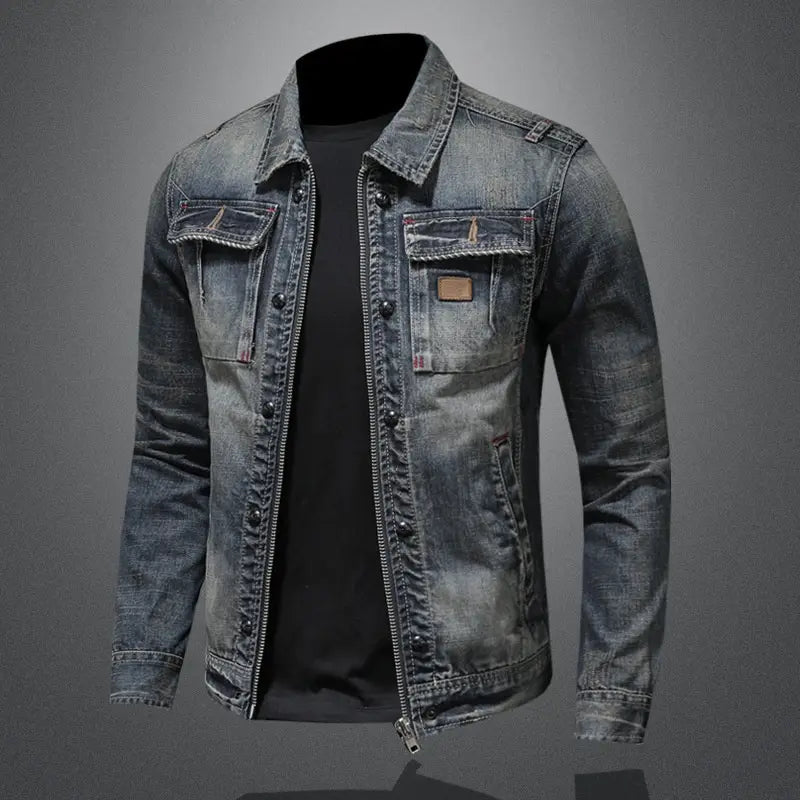 A faded blue distressed dark wash denim jacket for men featuring a classic collar, button and zipper closure, and two chest pockets with brown leather patches.