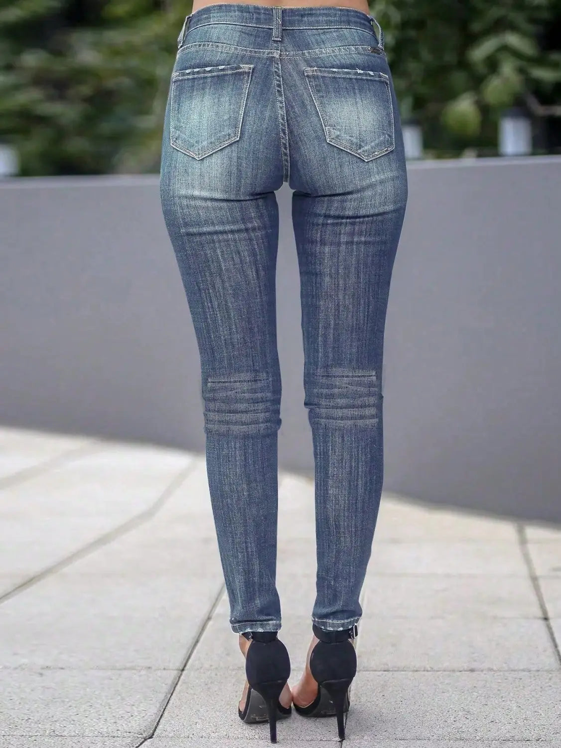 Women’s high-waisted stretch skinny jeans in blue denim with a slim fit and subtle distressing details.