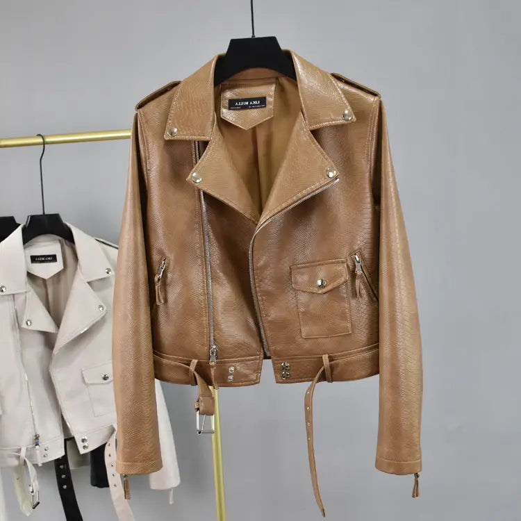 Tan crocodile faux leather cropped biker jacket with textured surface silver-toned zippers and hardware accents featuring a belt.
