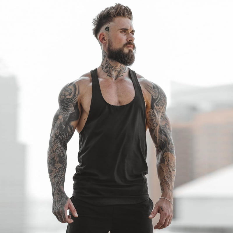 Men’s go hard racerback athletic tank top in black sleeveless fitted design with scoop neckline for performance and comfort.