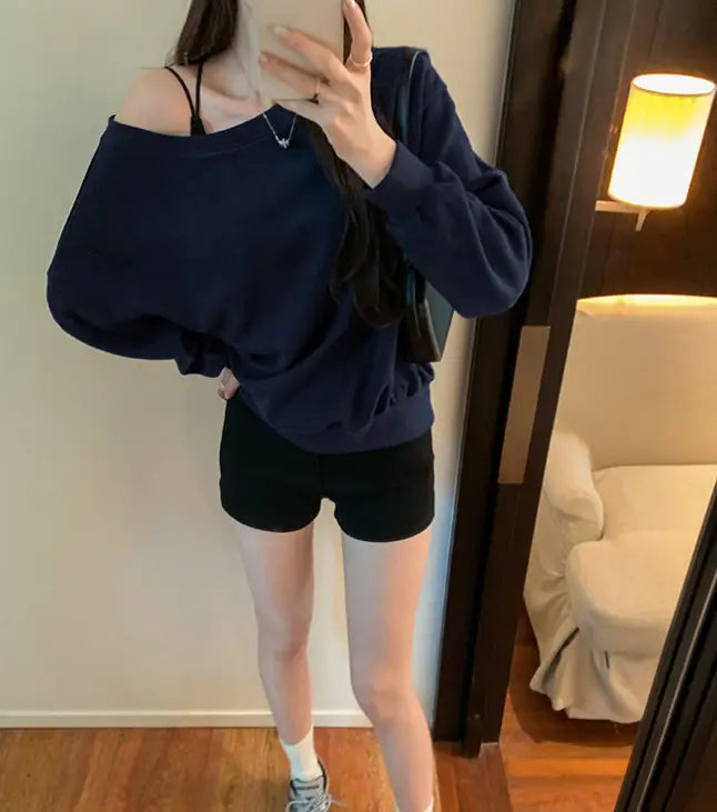 Navy blue women’s loose off shoulder ribbed knit sweater with long sleeves and a relaxed fit.