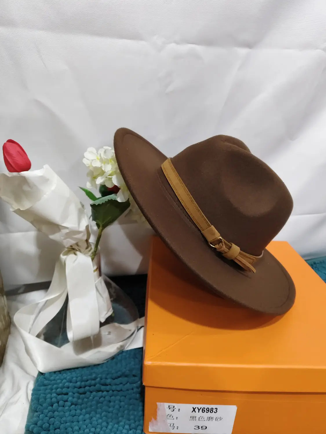 Brown wool fedora hat featuring a tan leather belt with buckle detail.