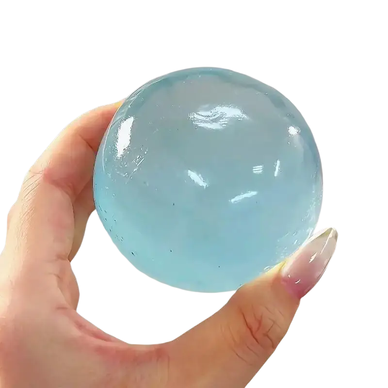 A translucent light blue fidget toy ball made of tpr material with coconut oil for stress relief and smooth glossy surface