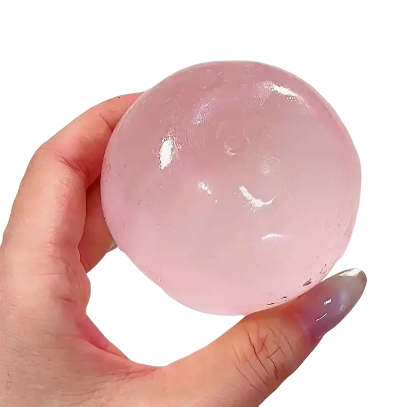 A translucent pink gel fidget toy ball made of tpr material with coconut oil for stress relief and sensory play