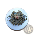Antique bronze filigree brooch with intricate floral and pomegranate design featuring a central red gemstone accent