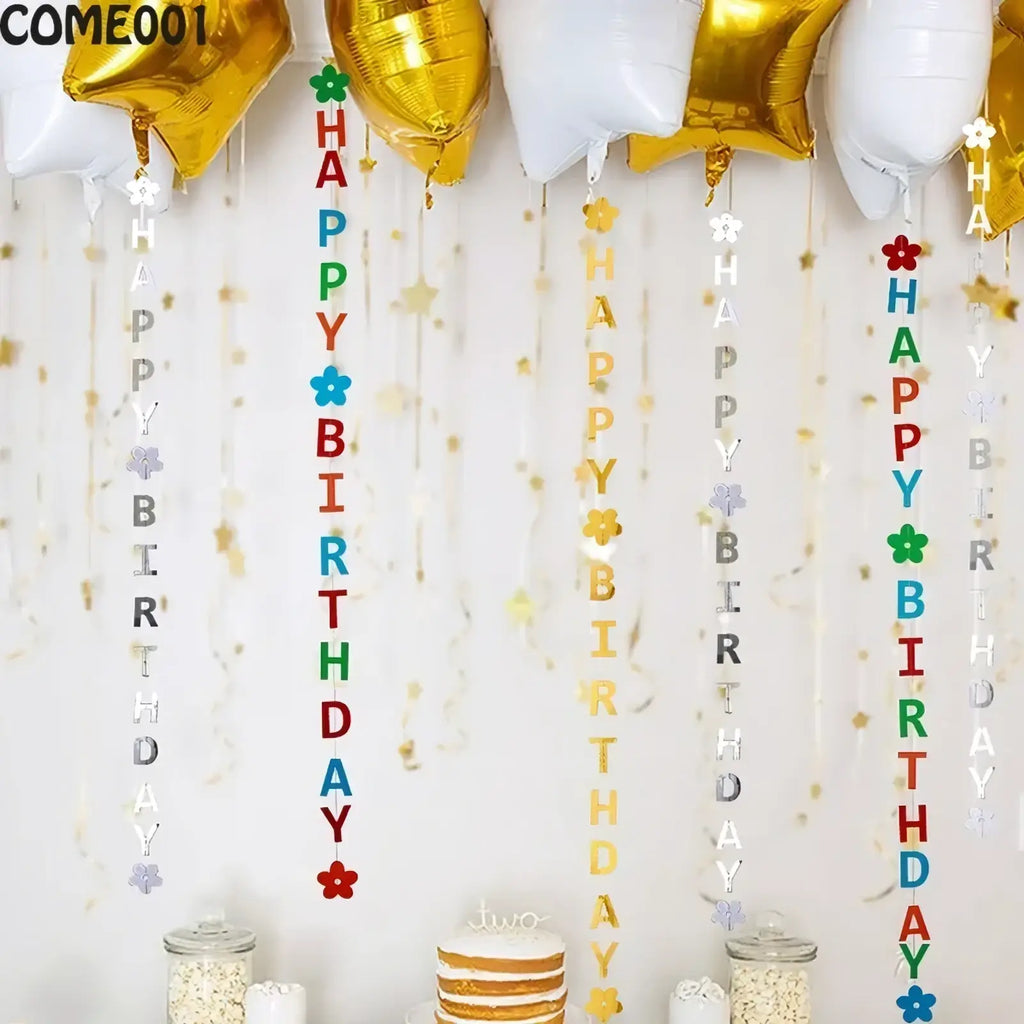 Colorful first birthday party bunting and banner decorations with happy birthday lettered charms and decorative flowers