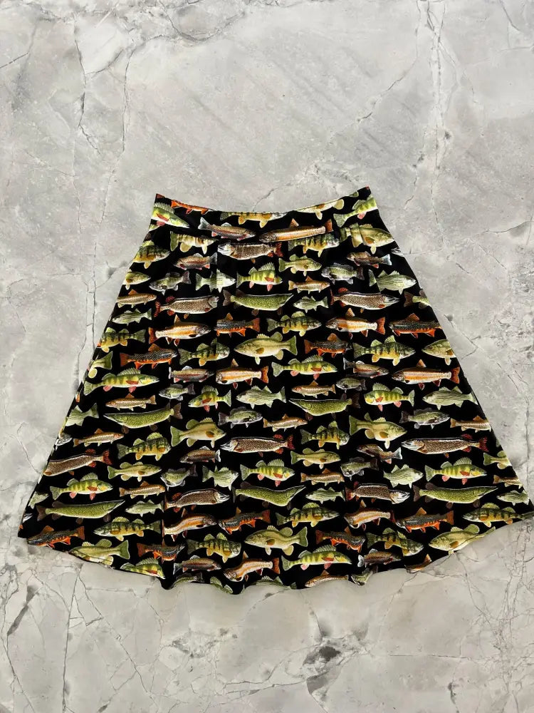 Vintage fish print cotton a-line skirt in black featuring colorful green brown and orange fish with pockets