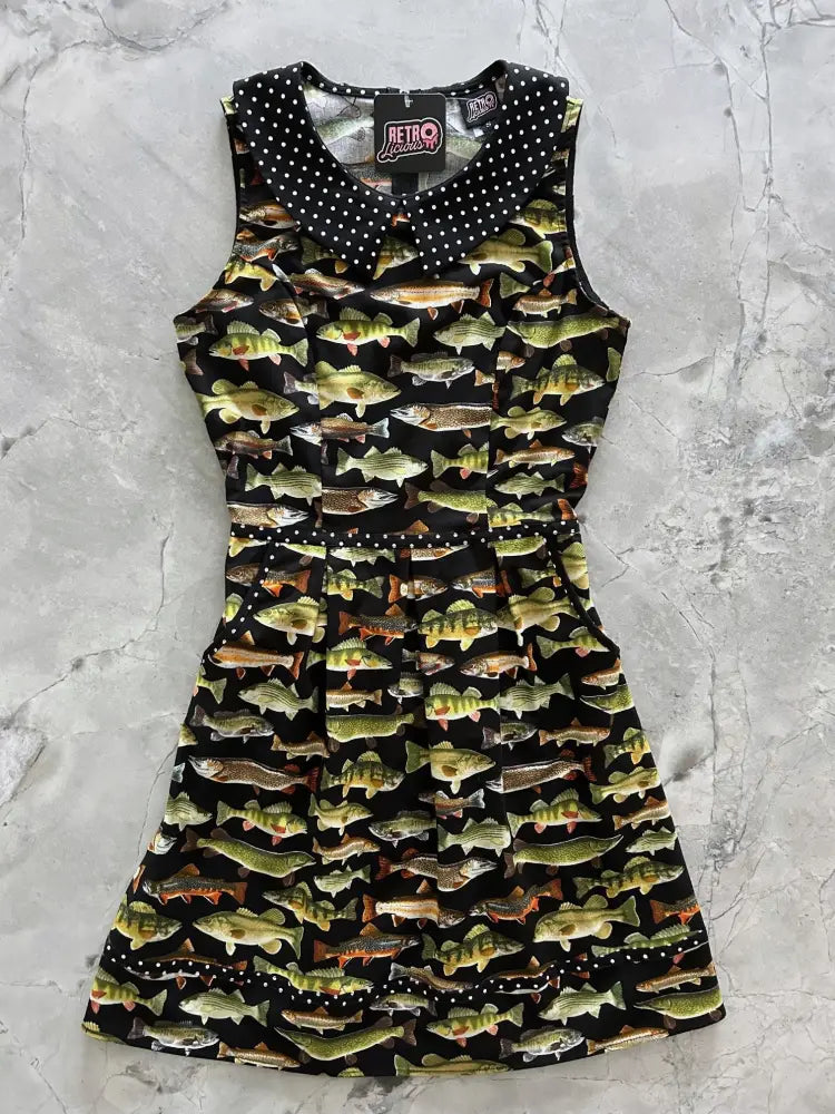 Black sleeveless dress with polka dot collar and all-over fish print featuring fitted bodice and flared skirt