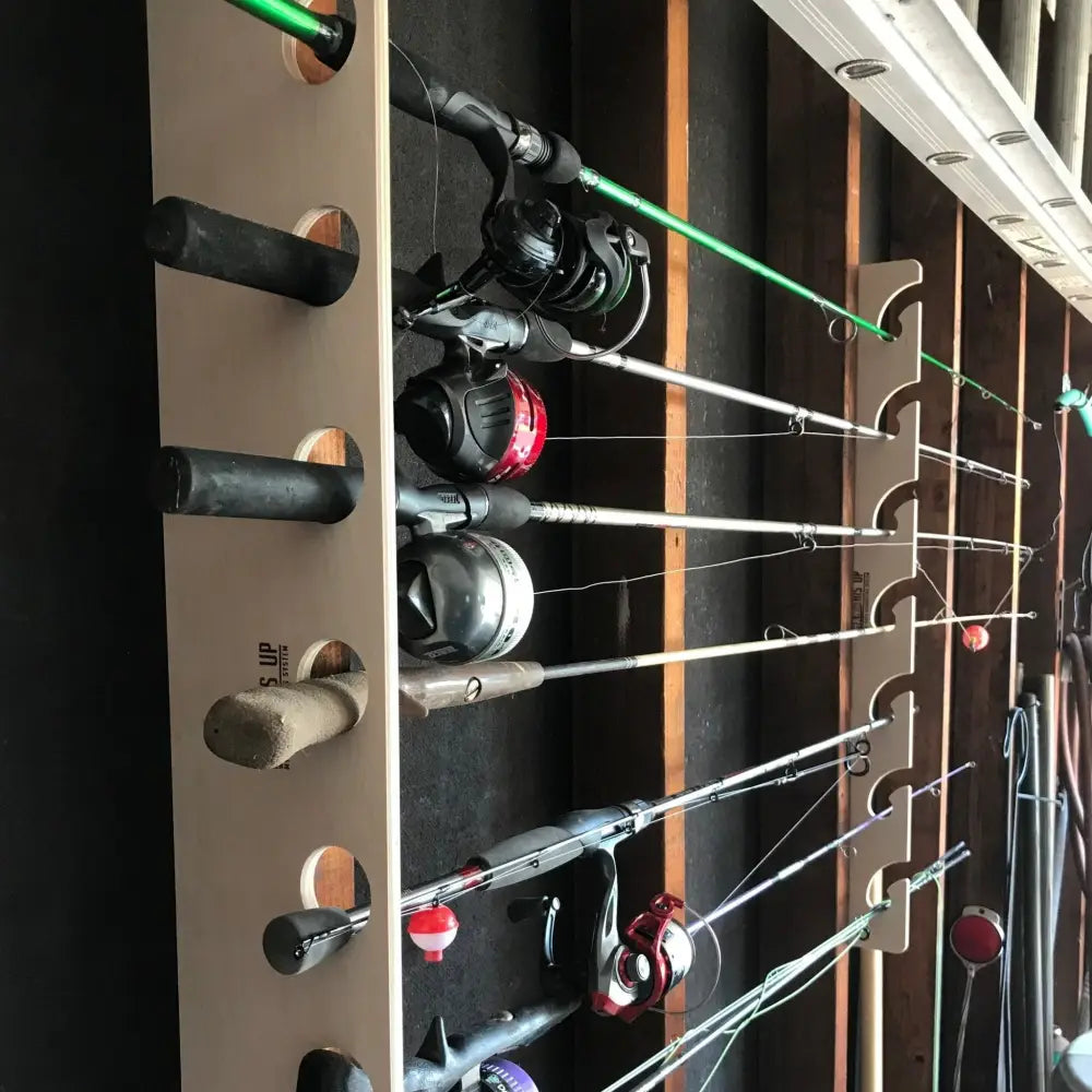 Beige handcrafted wooden fishing pole storage rack holding multiple rods with green silver and black reels