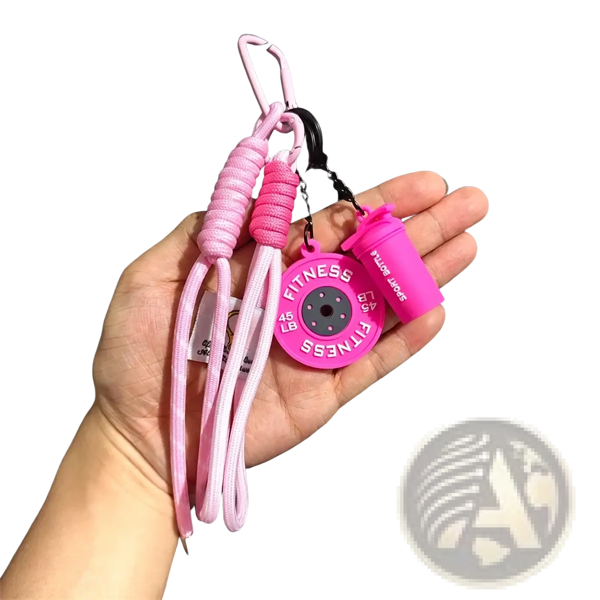 Pink silicone fitness keychain with a 45 lb weight plate charm and small shaker bottle gym bag charm