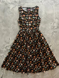 A black sleeveless flaming hearts 1950s style cotton midi dress with flared skirt multicolored heart and card patterns and pockets