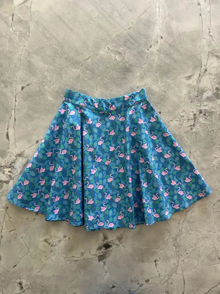 Teal flamingo print vintage skater skirt with a playful pattern of pink flamingos and green foliage