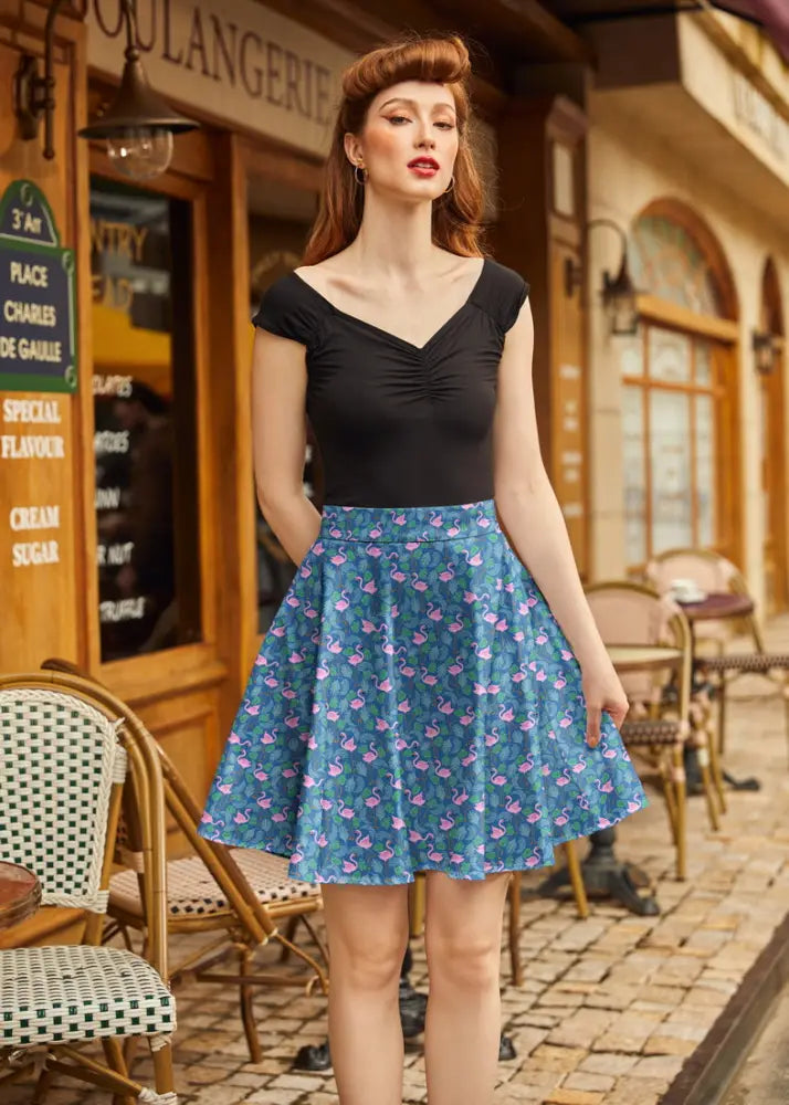 Teal flamingo print vintage skater skirt made of lightweight fabric featuring a pink flamingo pattern