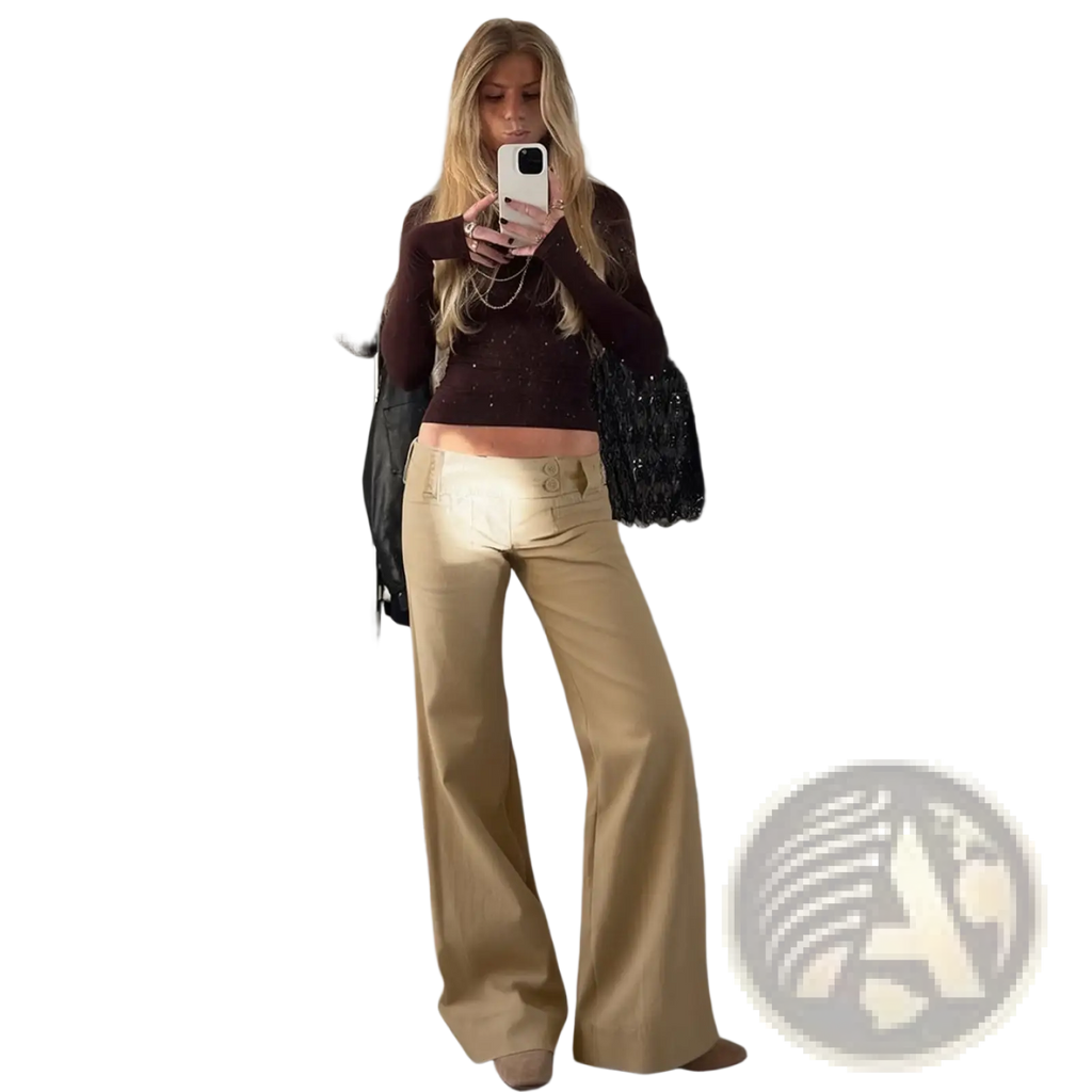 Flared tan low rise trousers in smooth glossy fabric with wide legs and two front buttons at the waistband