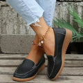 Women’s slip on pu leather loafers in black with tan rubber soles and white contrast stitching details