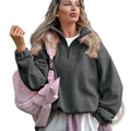 Pink puffer bag with shiny quilted exterior and adjustable strap paired with fleece half zip sweatshirt casual pullover