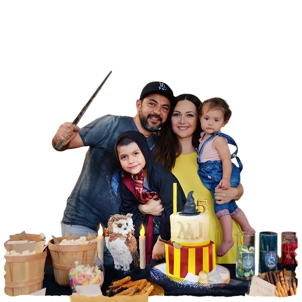 Yellow and red striped birthday cake with black witch hat topper featuring initials mj and floating candles with magic wand remote
