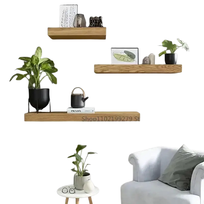 Three natural finish wooden wall mounted floating shelves with hidden compartments holding plants and framed art